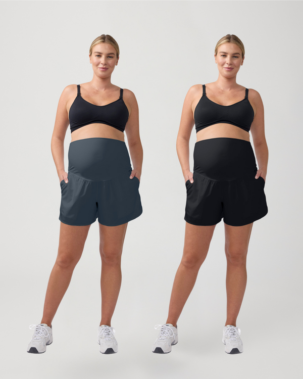 Two women wearing black sports bras and shorts on a white background